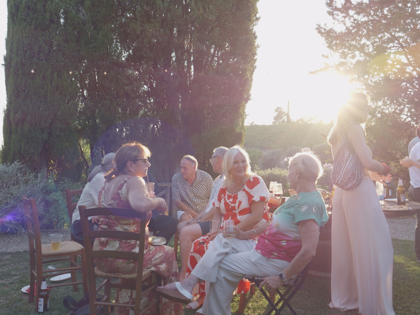Guests sitting together in the garden at sunset