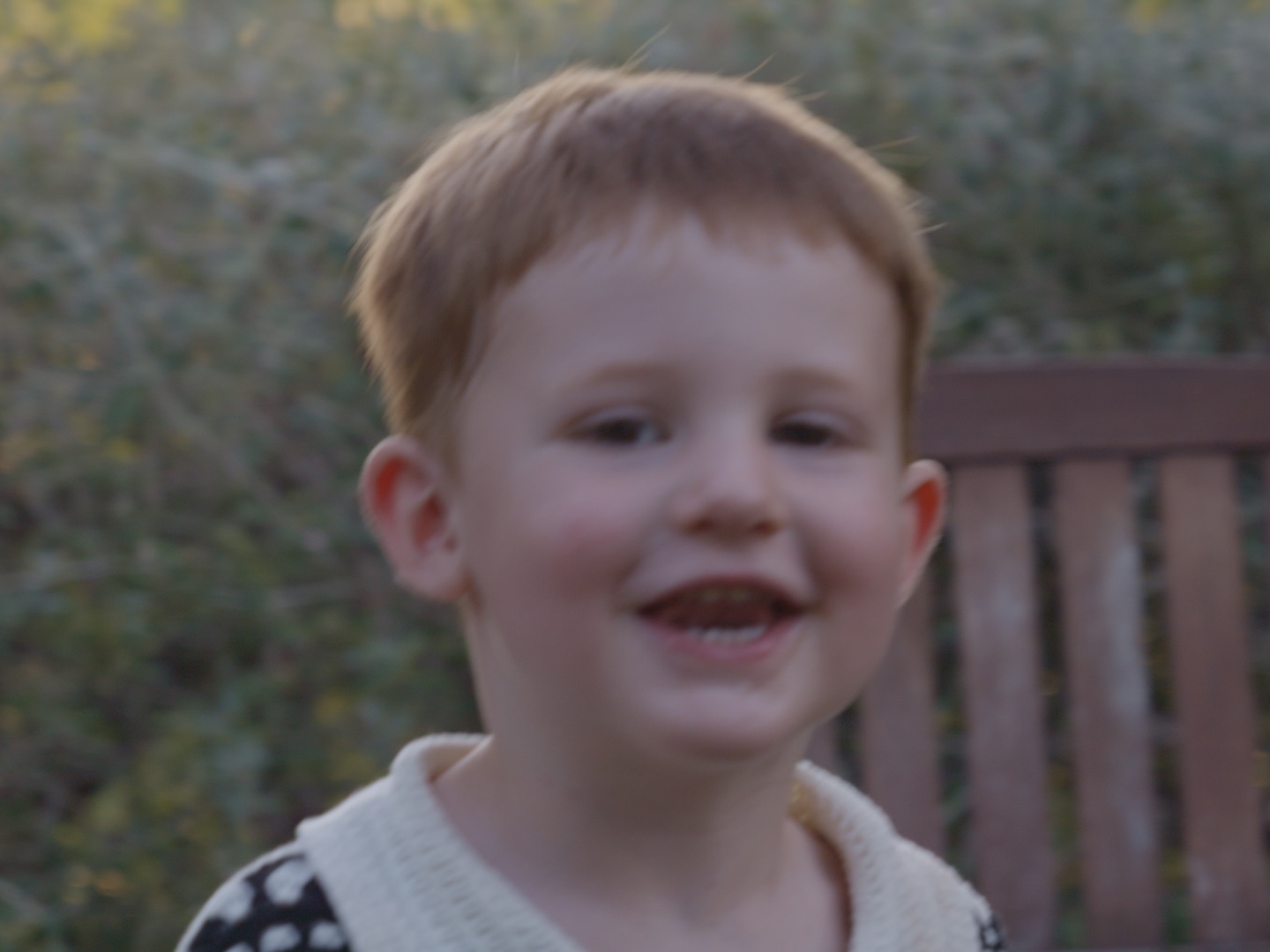 A young guest smiling during the pizza party
