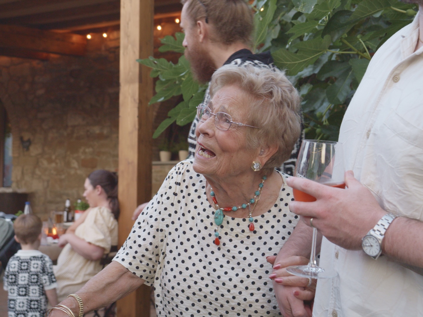 A small group of guests eating pizza at an intimate event in the Tuscan countryside