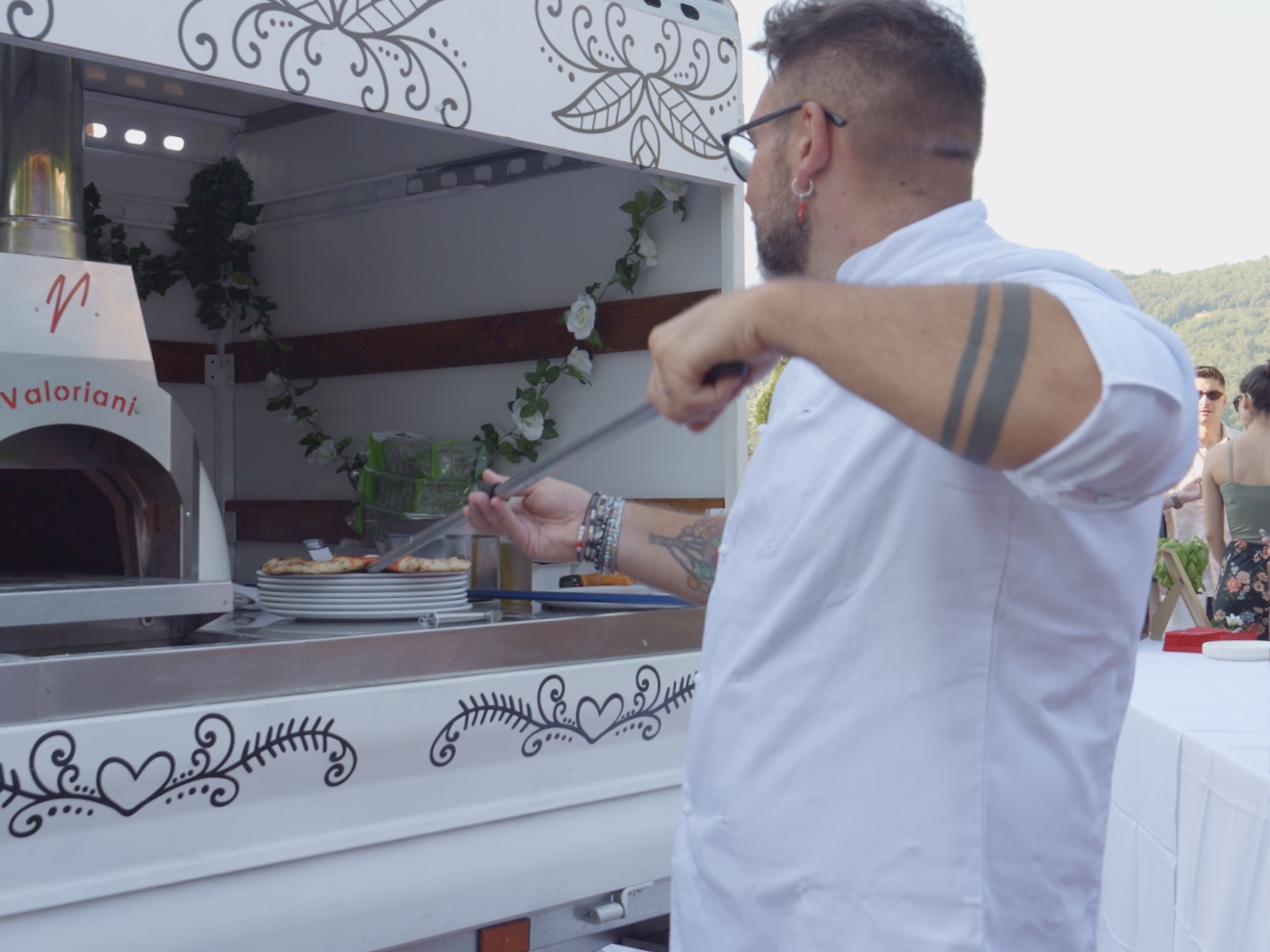 Neapolitan pizzas coming out of the gas oven during a wedding week event in Tuscany