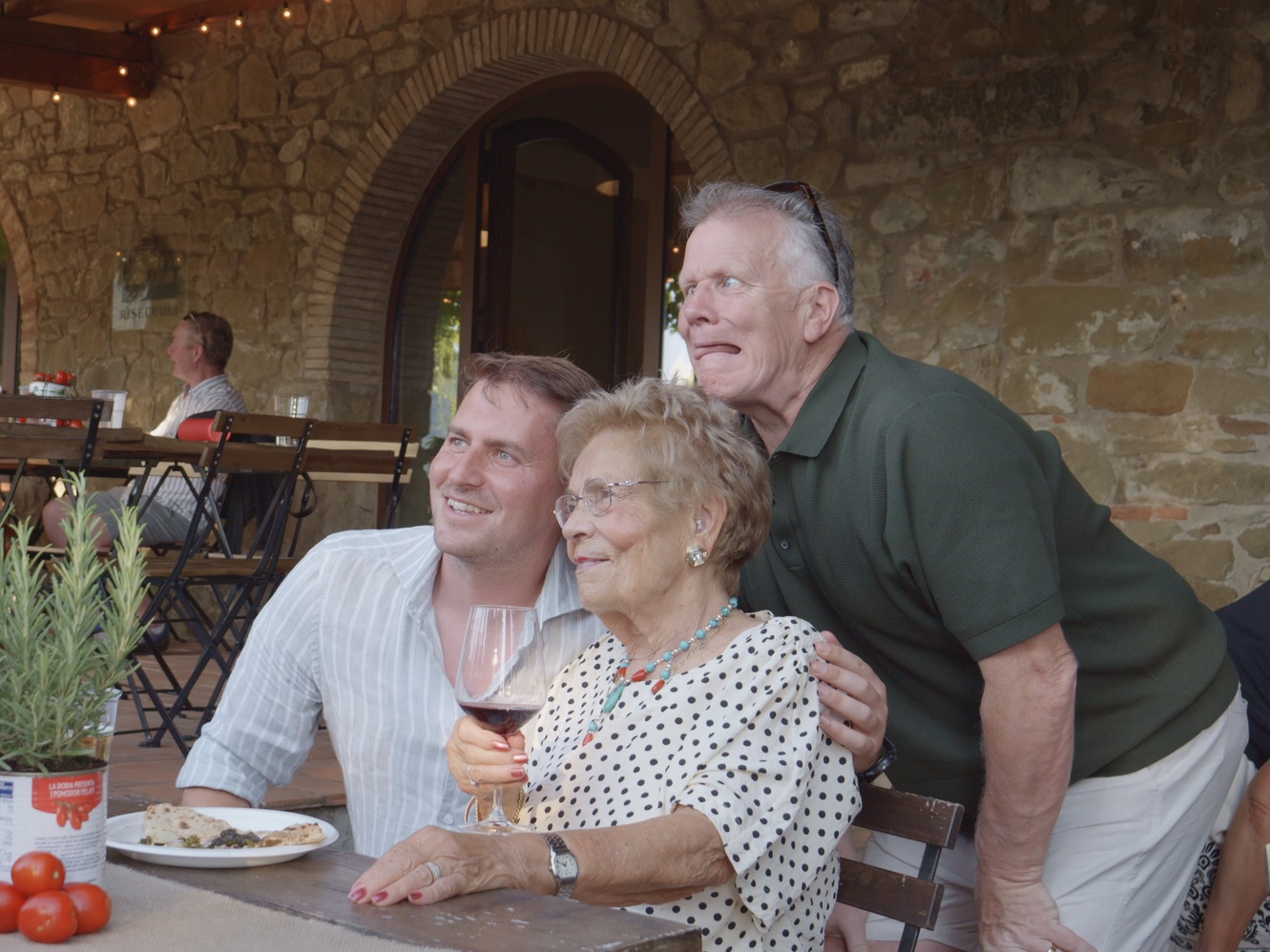 Three guests posing together at the table during the party