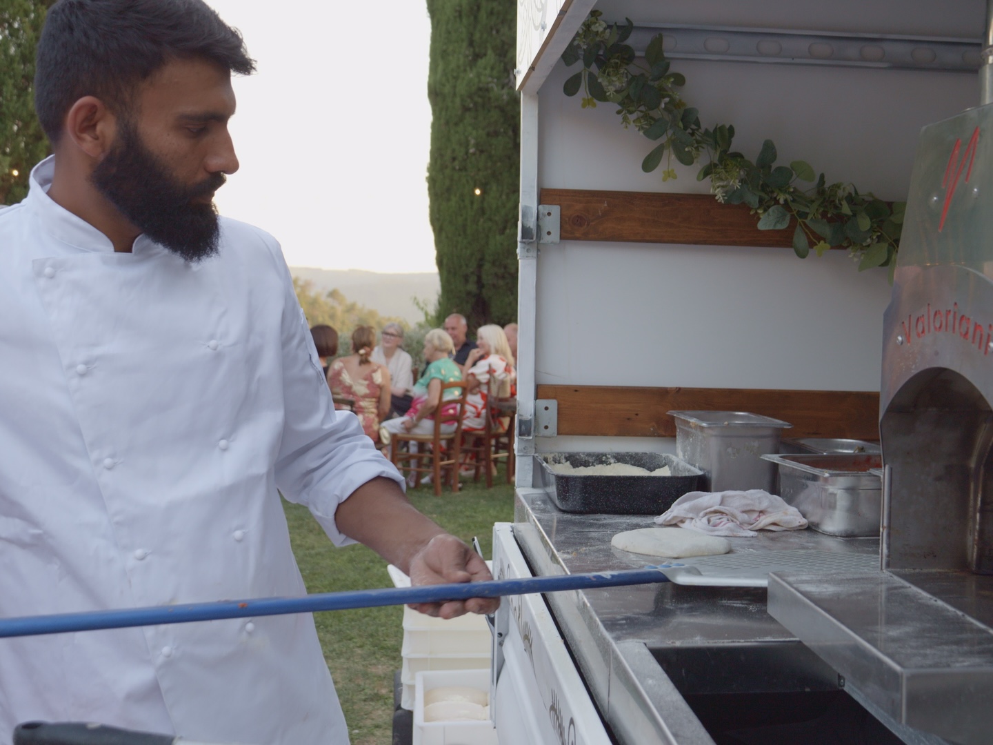 Gas-fired mobile pizza oven in operation at a Tuscan wedding venue