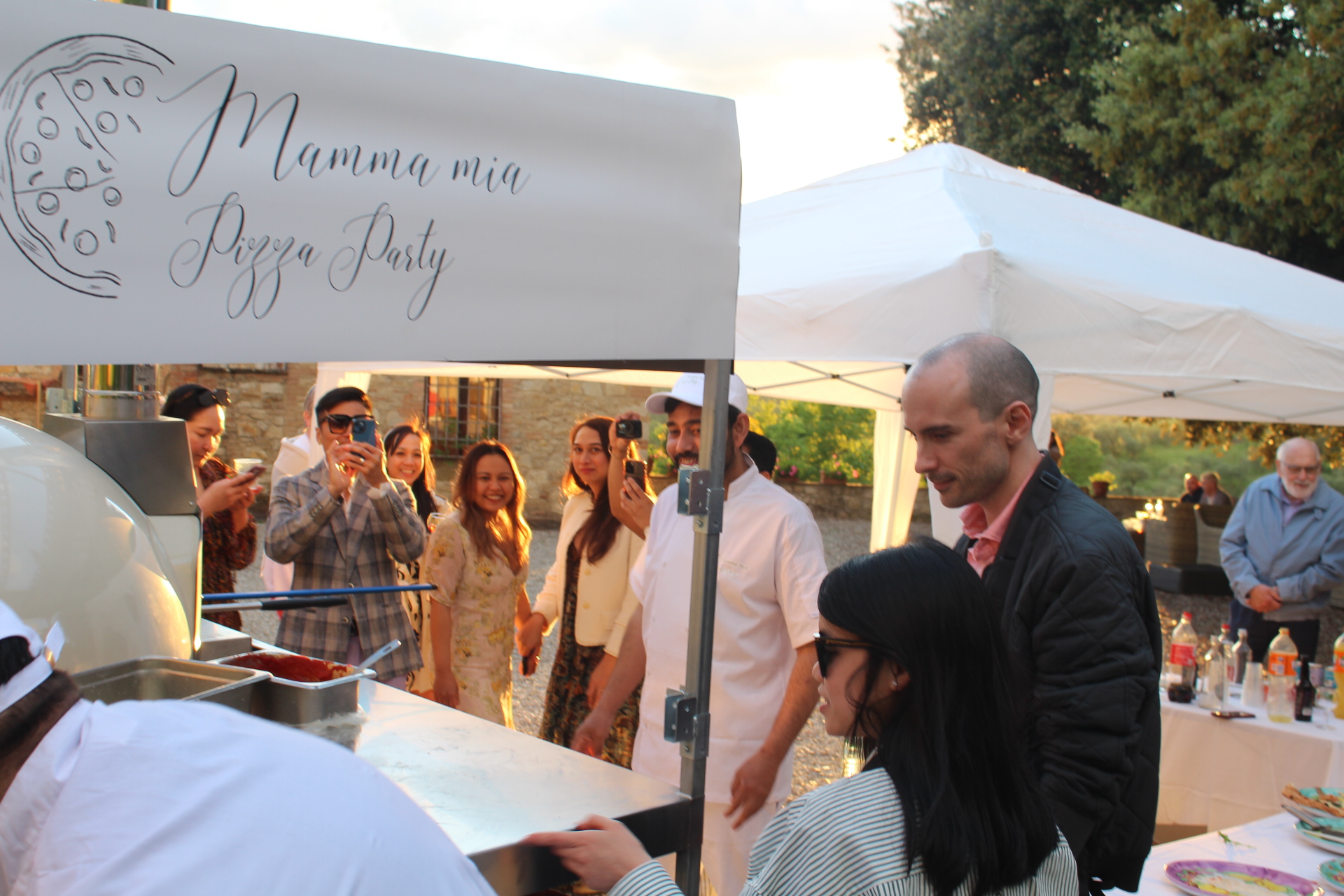 Guests gathered around our pizza van at a wedding in Tuscany