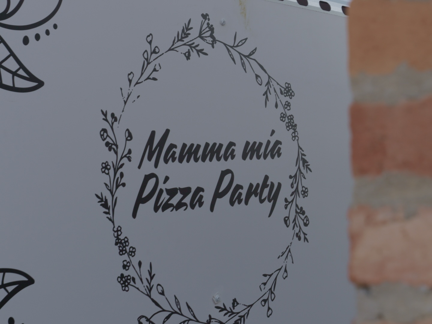The Mamma Mia Pizza Party logo painted on the side of our truck
