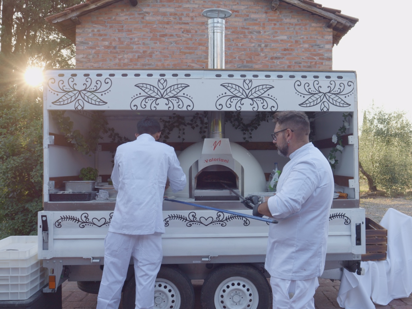 Couple and guests being served pizza at a Tuscan wedding venue