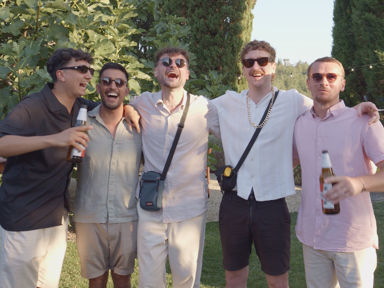 Large wedding group being served pizza at a Tuscan villa